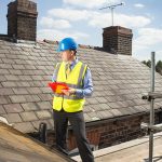 builder assesses slate roof condition