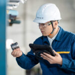 Unmasking the Flaw: The Architecture of Product Liability and Forensic Engineering asian male engineer working with digital tablet in factory