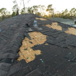 Natural disaster and its consequences. Hurricane Ian destroyed house roof in Florida residential area
