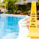 What the Water Left Behind: Proving Liability on the Pool Deck Wet floor warning